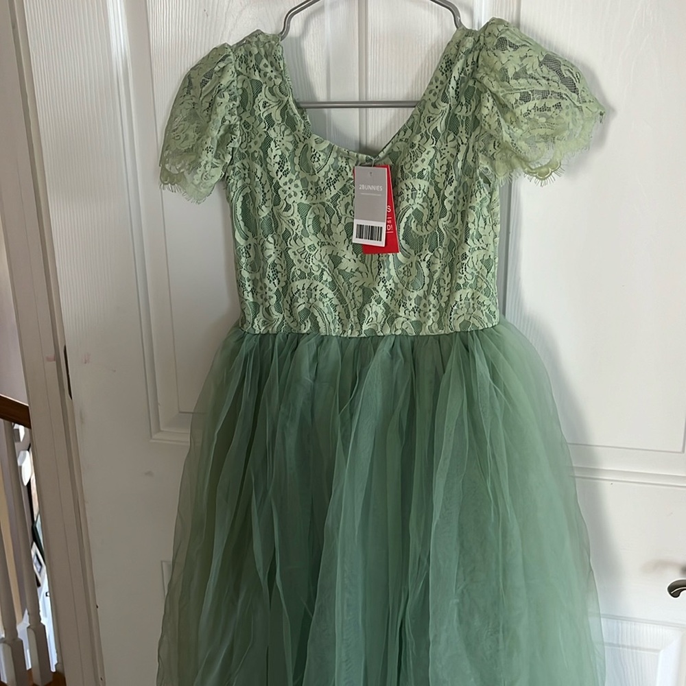 NWT did not fit. Runs slightly smaller. Lace top, tulle bottom.